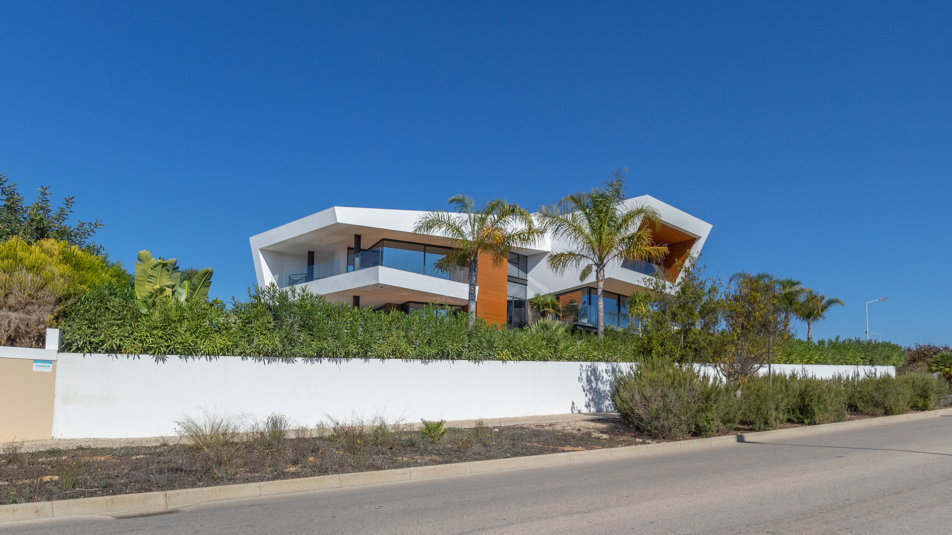 Truly Stunning 4 Bedroom Villa with Large Pool and Sea Views in Lagos | LG1860 This breath-taking villa boasts a plot totalling 1520m² with living area of 221m². This bespoke design by Carlo & Carla Architects has cleverly maximised the use of space, and amazing views, whilst optimising the natural light. Panoramic views are offered through floor to ceiling windows which open to large wooden covered terraces, to the beautiful garden and large heated pool.